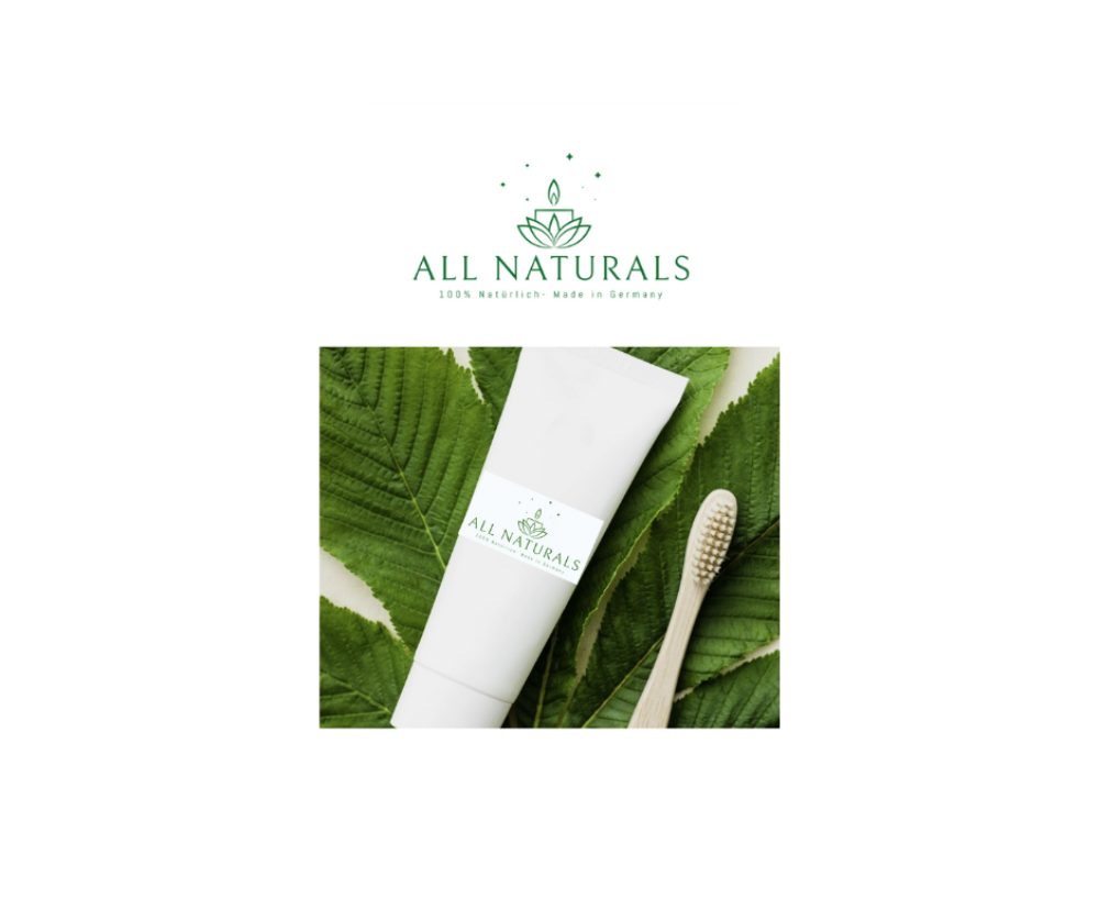 Natural toothpaste with mint and hydroxyapatite on green leaves with bamboo toothbrush.